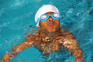 Young Boy With Goggles In The Pool